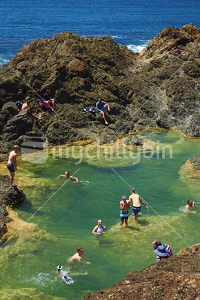 Mermaid Pools with swimmers near Matapouri Bay on the Tutukaka Coast