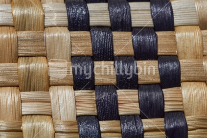 Macro closeup of Maori flax weaving - takitahi weave with shiny fibre detail