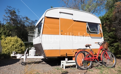 Orange caravan and vintage style bike