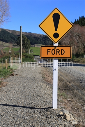 Ford warning sign on country road.