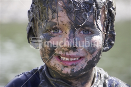 Boy with mud on face