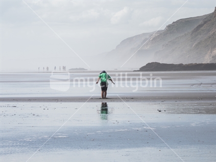 Boy on beach in low tide (High ISO)