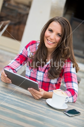 Woman using tablet at cafe