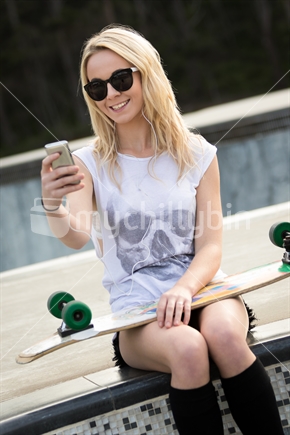 Blond teen skater girl taking selfie