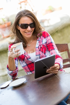 Beautiful woman using tablet, with coffee!