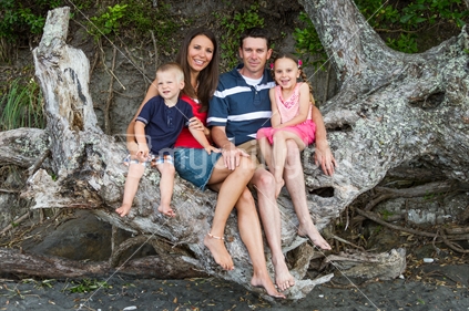 Happy family sitting in tree