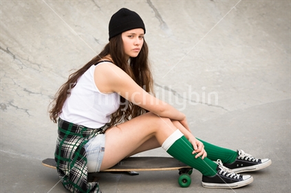 Beautiful teenage Maori girl on skateboard