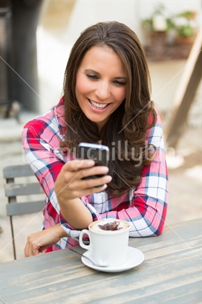 Woman reading text message on mobile phone