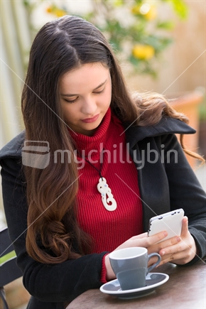 Beautiful maori woman using a mobile phone