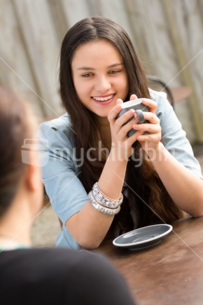 Two maori women drinking at cafe