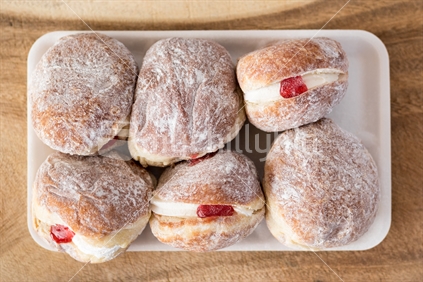 A pack of six cream filled donuts