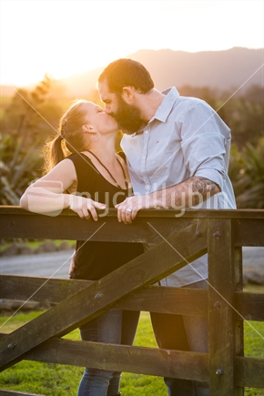 Loving couple kissing at sunset