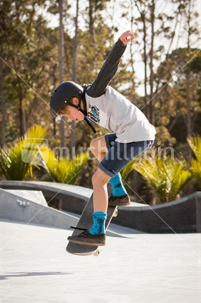 Skateboarding boy doing a jump trick
