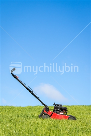 Lawn mower in green grass