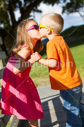 Brother and sister children kissing