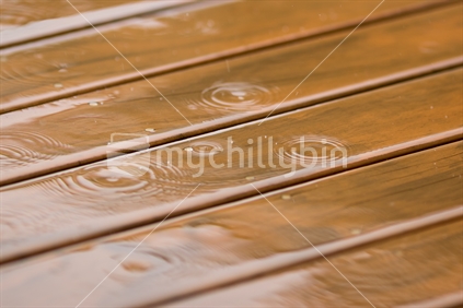 Rain splashing on wooden deck