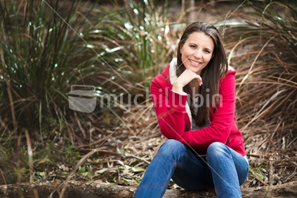 Smiling woman sitting in the bush