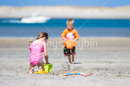 Children playing in the sand at the beach