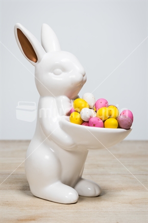 Porcelain easter bunny holding eggs