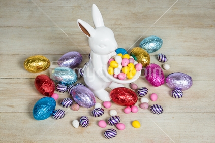 Colourful easter eggs and bunny on straw