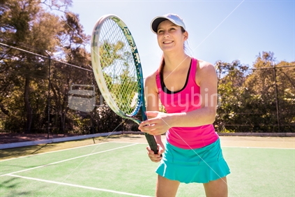 Pretty young woman playing tennis