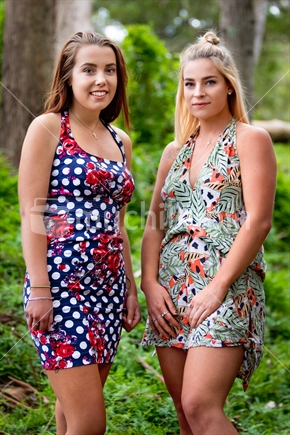 Two girl friends standing in bush