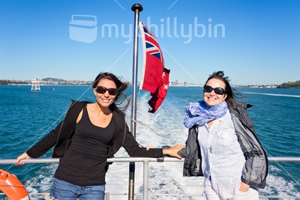 Two women on boat with NZ flag