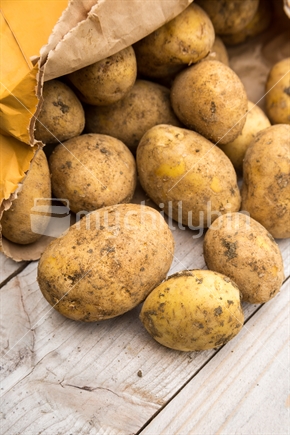 White potatoes on wood table