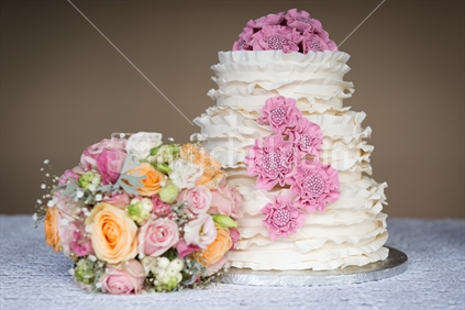 Wedding cake and bridal flowers bouquet