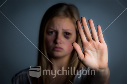 Domestic violence victim with hand up to say stop Available image uses with this image are broader than the regular mychillybin licence terms, specifically permitting use to illustrate domestic violence. Pornographic and defamatory use are still not permitted.