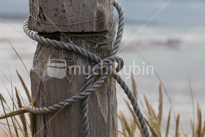 Closeup of rope tied to a post