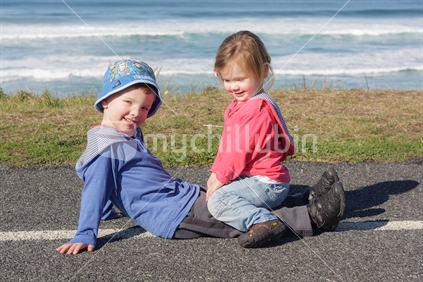 Brother and sister having fun by the beach (St Kilda, Dunedin).
