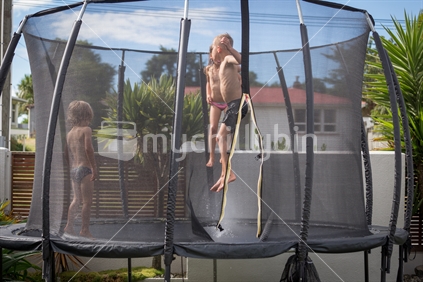 Kids on trampoline on a hot summer day