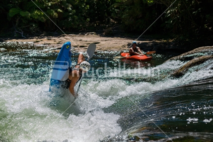 Kayaker almost vertical, in river