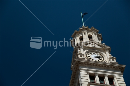 The clock tower of the Auckland town hall with the blue sky.  Taken in Auckland city.