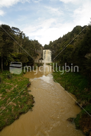 Hunua falls with the sky, forest and the stream.  Taken after a storm.