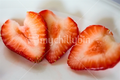 Three slices of a strawberry.