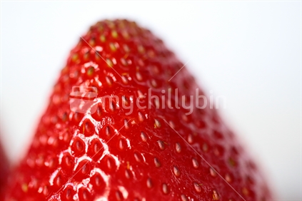 A close up of the end of a strawberry.