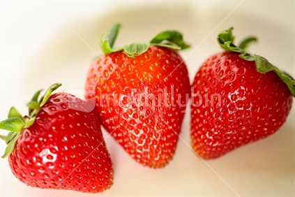 Three strawberries together.