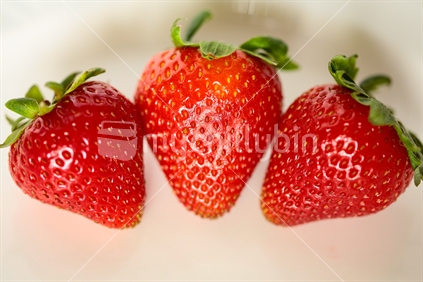 Three strawberries together.