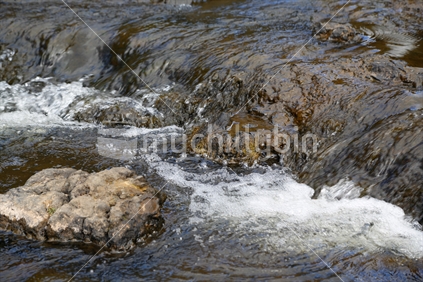 River water over rocks. Hunua falls.
