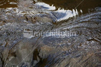 Water of a river over rocks. Hunua falls.