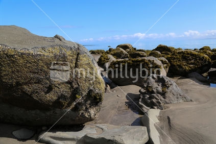 Large rocks on a beach.  Taken in the Raglan area.