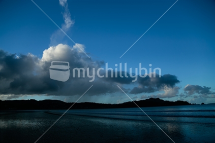 A view of Buffalo beach in Whitianga, with reflection of the sky.