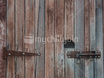 Rustic wooden door with lock and hinge