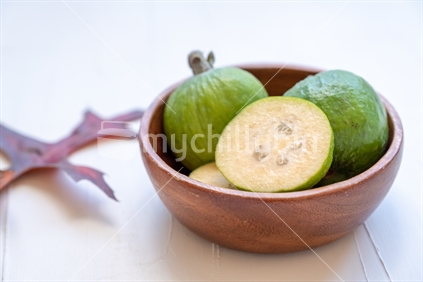 cut feijoa in a wooden bowl