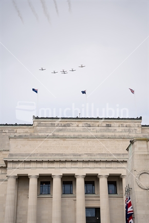 Auckland museum with war birds flying over (focus flags)