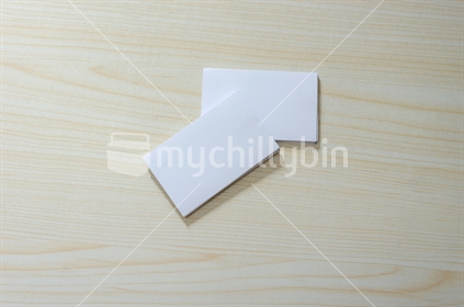 Blank Paper Mockup for Business Cards on wood.