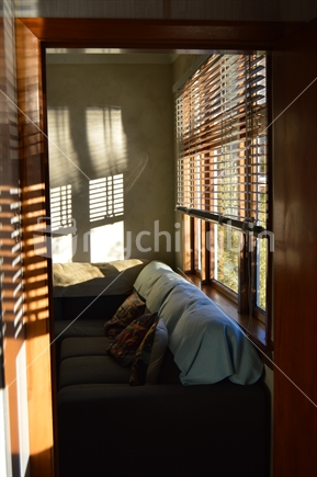 Peaceful afternoon sunlight through window blinds in old mosgiel house