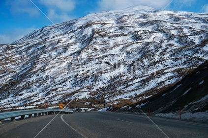 Road moving towards snowy mountain